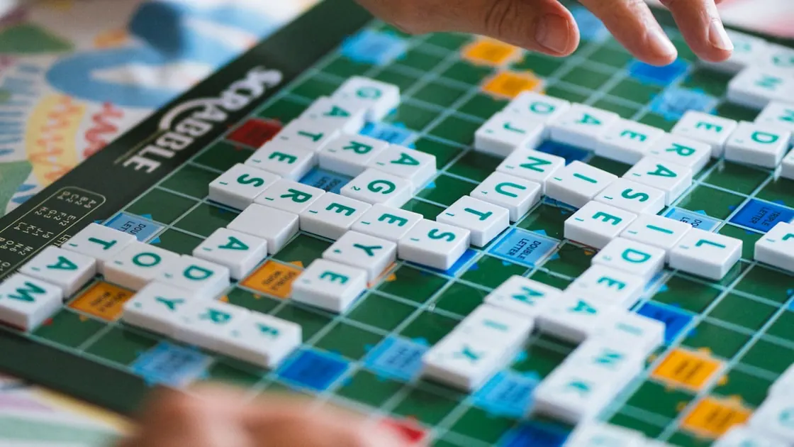 Two people playing a word game with letter tiles — the players our anagram solver is built for